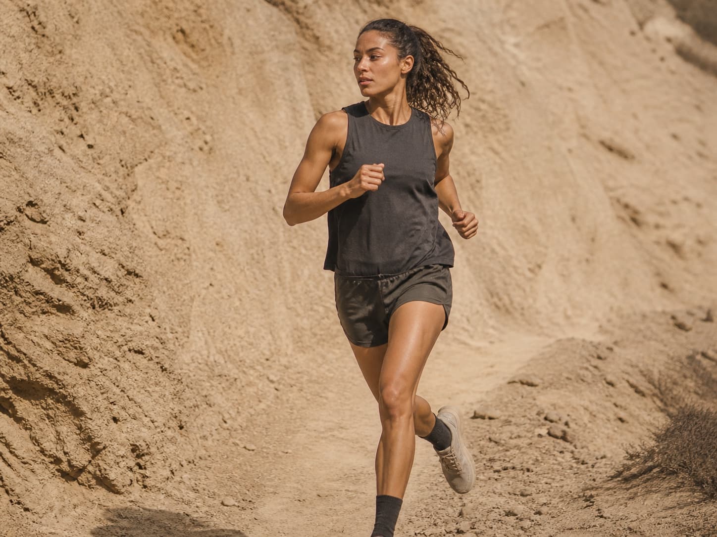 Trail runner on a desert hillside